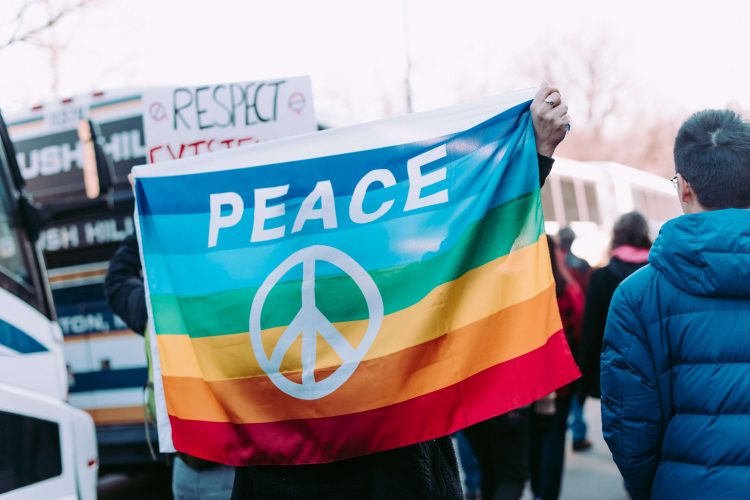 BostonUSAliceDonovanRouse2017.jpg People Holding Peace Banner and Respect Sign